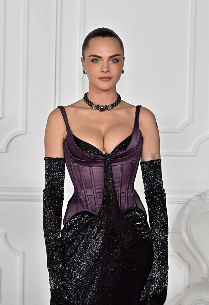 Frontal close up of Cara Delevingne in a corset