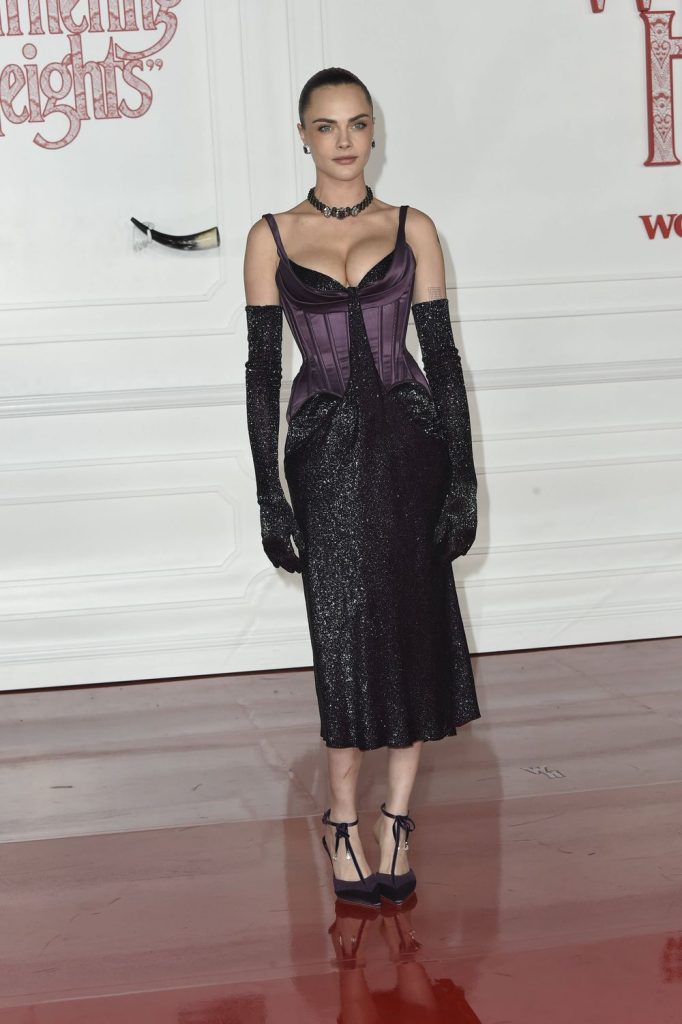 Full body angled frontal of Cara Delevingne posing for the camera