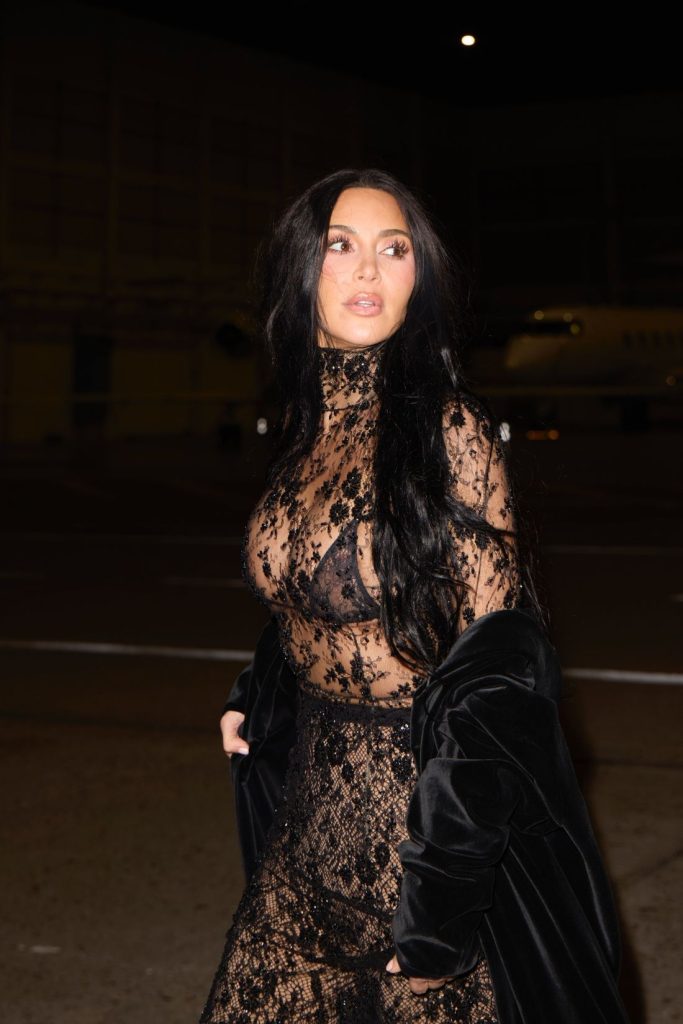Side view of Kim Kardashian walking and turning her head at night