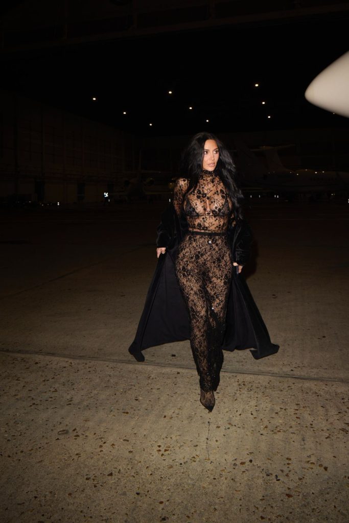 Far away frontal of Kim Kardashian walking