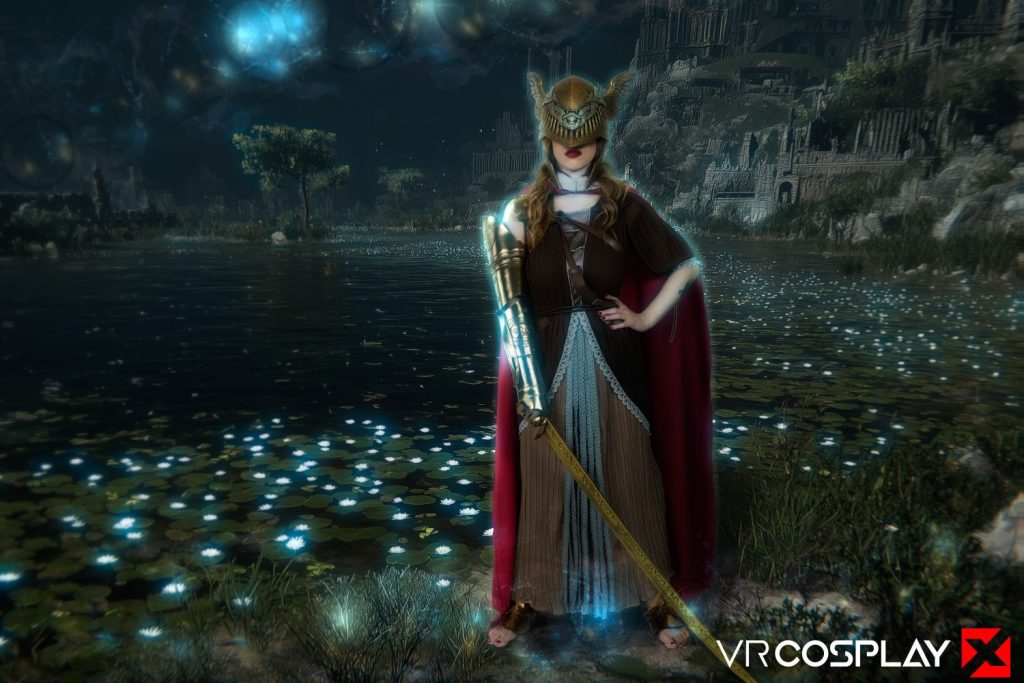 A person in elaborate fantasy armor with a gold helmet and red cape stands by a glowing lake at night, holding a large sword. There are floating lights in the sky and a castle in the background.
