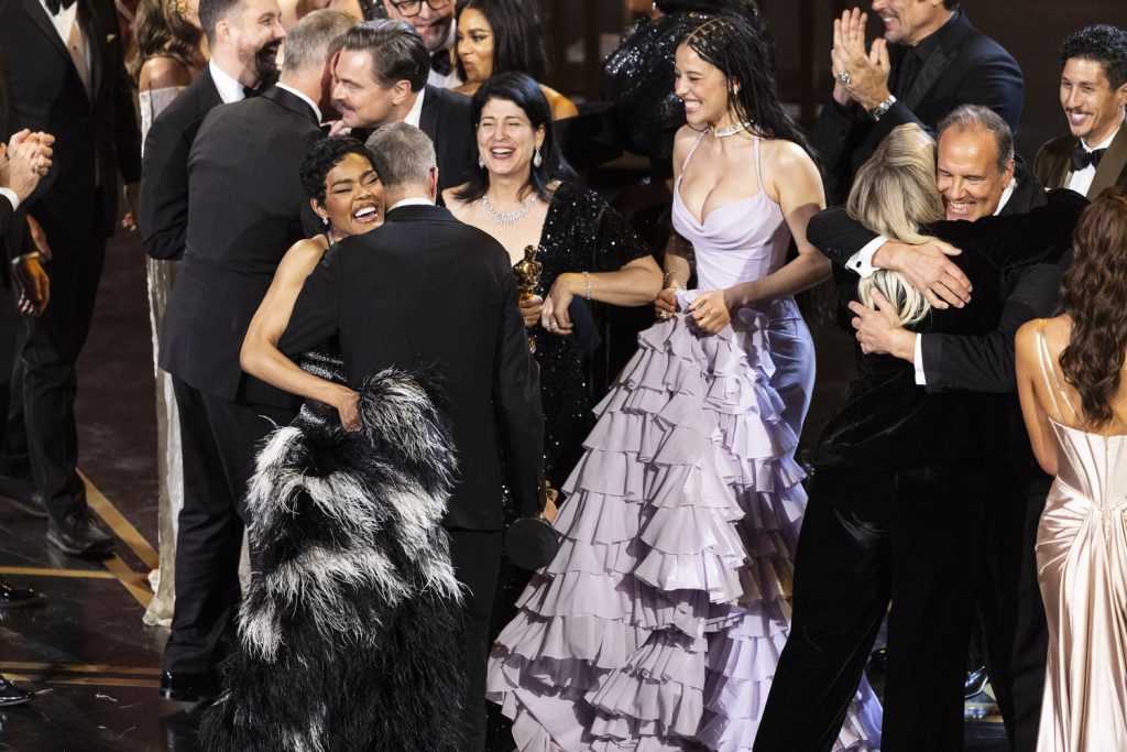 Various celebrities celebrating a win at the Oscars