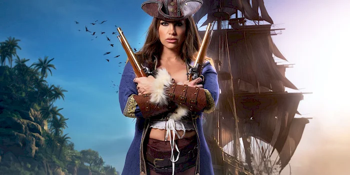 A woman dressed as a pirate stands confidently holding two pistols, with a tall ship and a tropical island in the background.