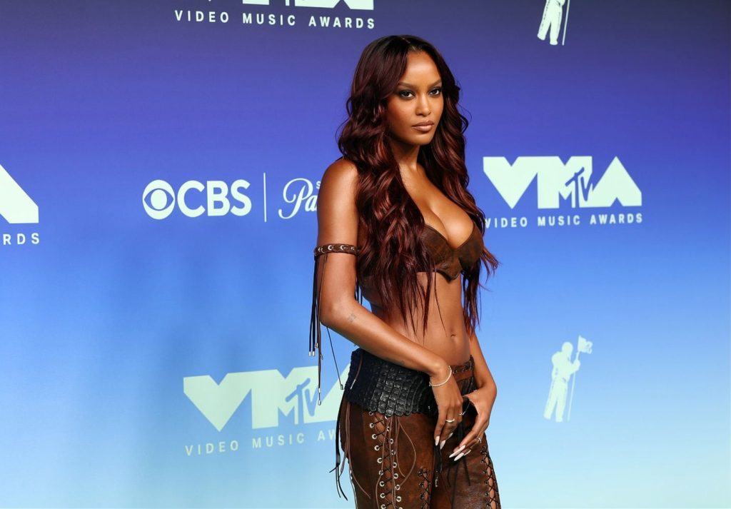 Ciara Miller poses in a two-piece brown outfit on the red carpet at the MTV Video Music Awards.